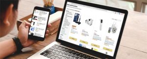 A shopper comparing products across a smartphone and laptop, demonstrating how consumers move seamlessly between digital channels before purchasing.